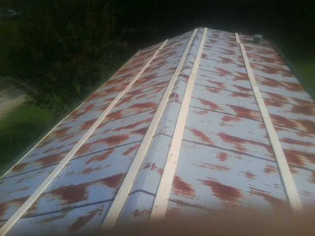 Rusted metal roof panels with new wood purlins before replacement — Storm Damage Roof Repair in Bourneville by Roofing Brothers